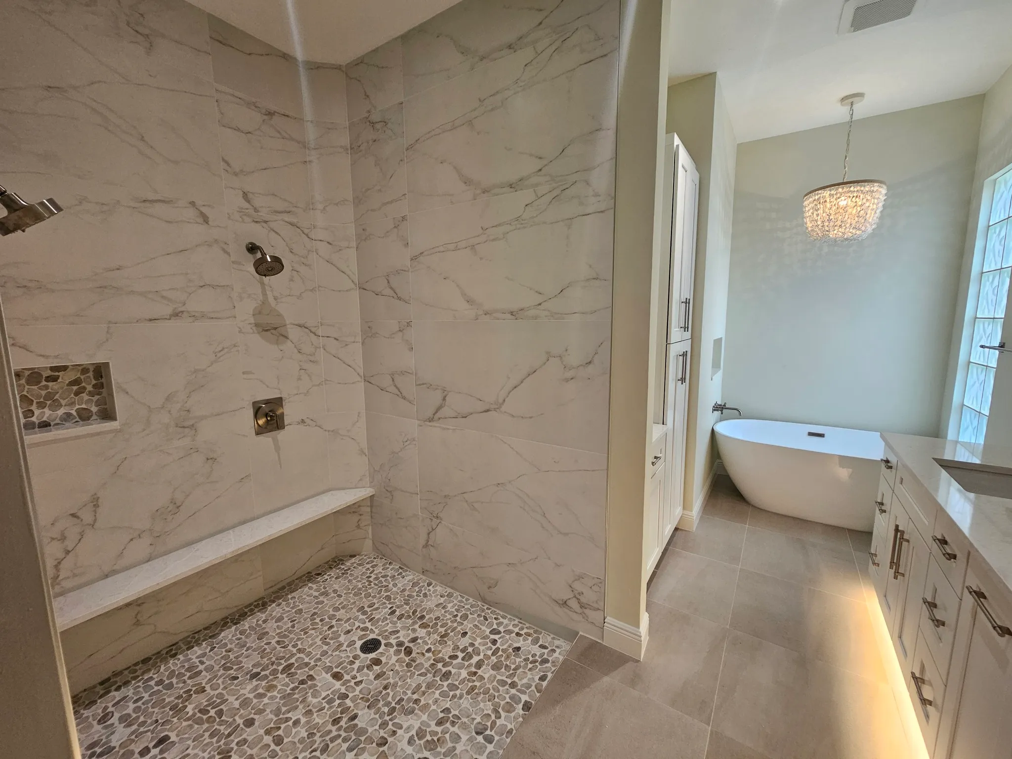 High-end primary suite and master bathroom renovation in Marco Island FL featuring custom marble and woodwork